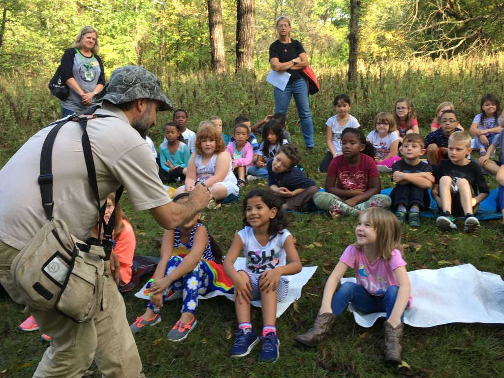 MRBO Director Ethan Duke shows a Black-capped Chickadee to a 2nd grade class at the Columbia Audubon Band With Nature event.